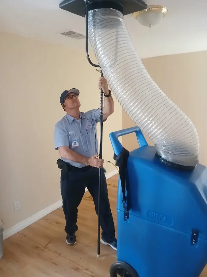 Furnace Tune-Up technician using HEPA equipment in San Bernardino